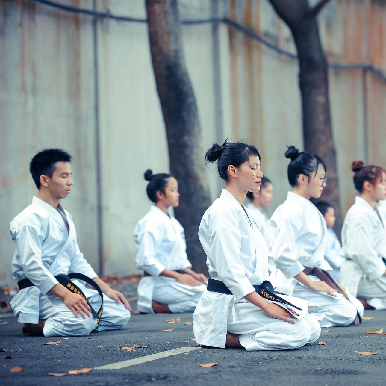 group of martial artists sitting on the grounds