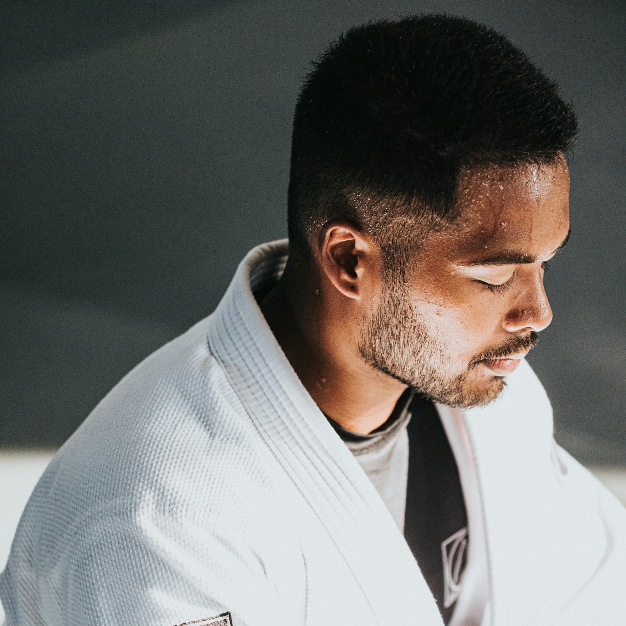 a man in a white kimono sitting down
